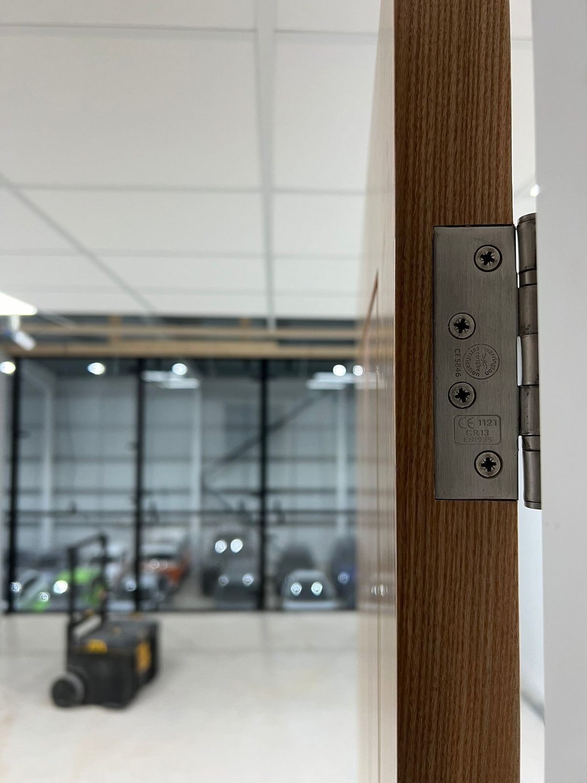 CE-marked EN1935 certified fire door hinge on an oak fire door installed in Leicester