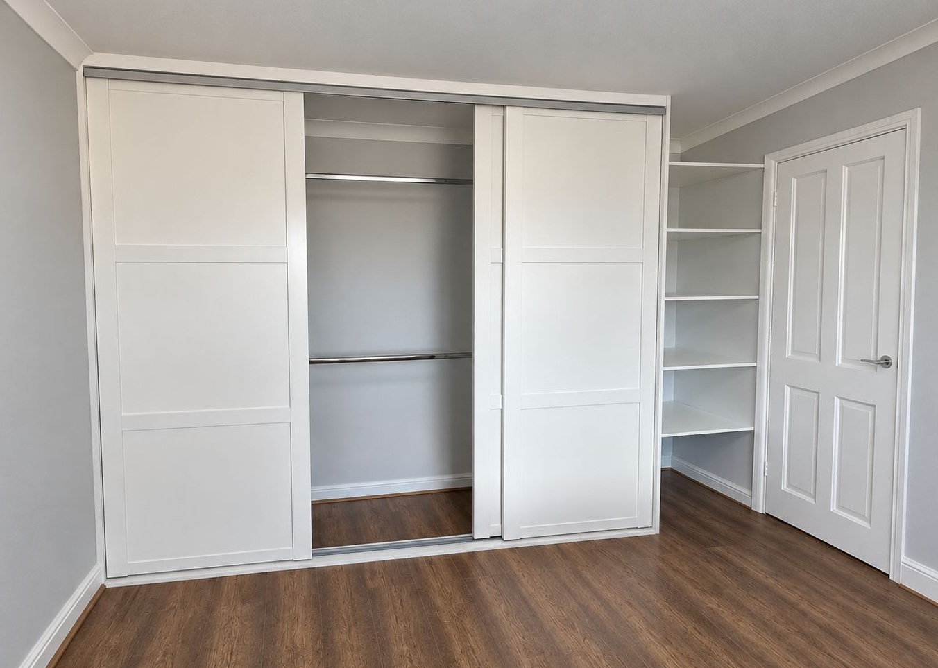 Fitted sliding-door wardrobe with shelving in a Leicester bedroom
