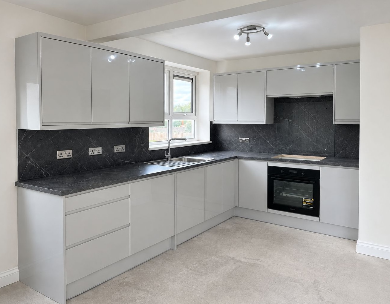 Grey gloss kitchen with marble-effect worktops fitted in Leicester