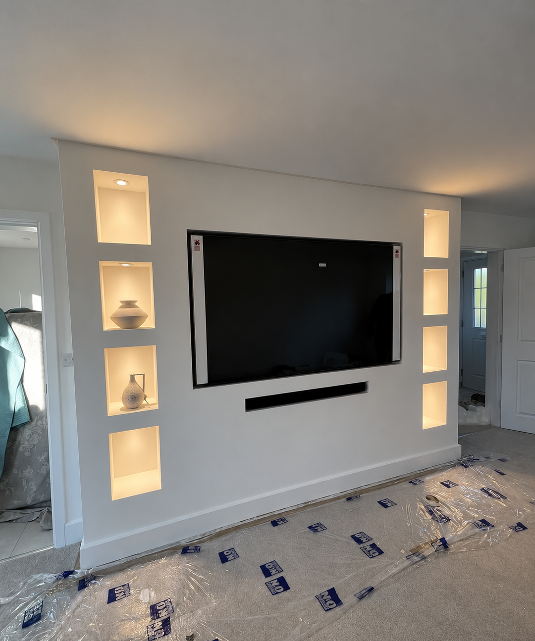 Media wall with recessed TV, fireplace and lit display niches in Leicester